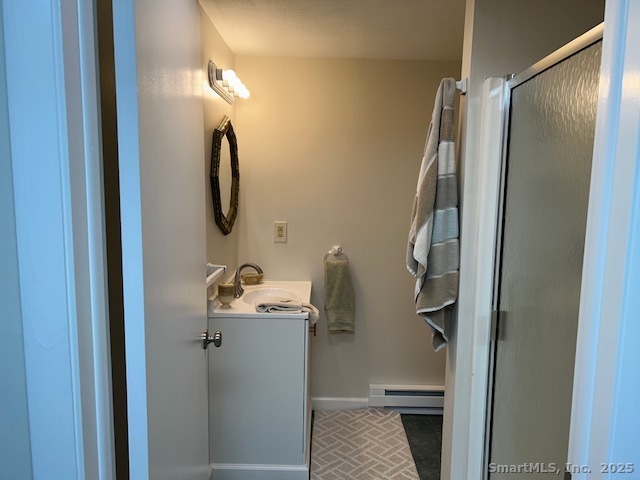 24 Colonial Drive Waterford, CT 06385 - Photo 23 of 25 a bathroom with a sink and mirror
