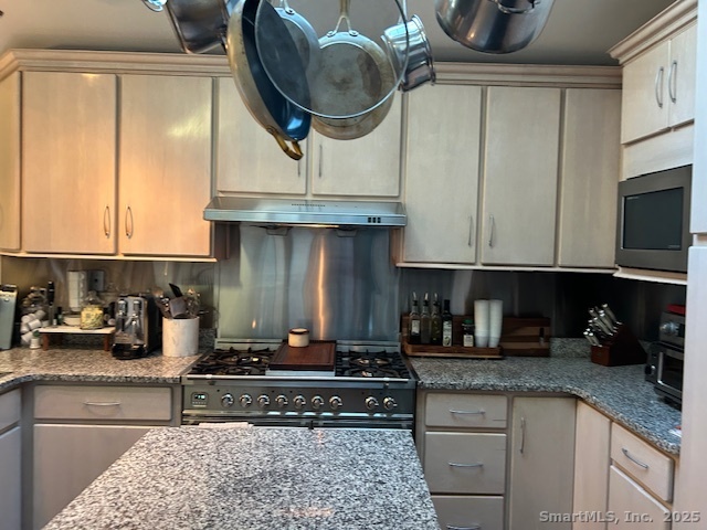24 Colonial Drive Waterford, CT 06385 - Photo 7 of 25 a kitchen with a stove a microwave and cabinets