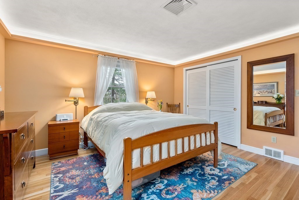42 Bradyll Road Weston, MA 02493 - Photo 16 of 31 a bedroom with a bed and wooden floor
