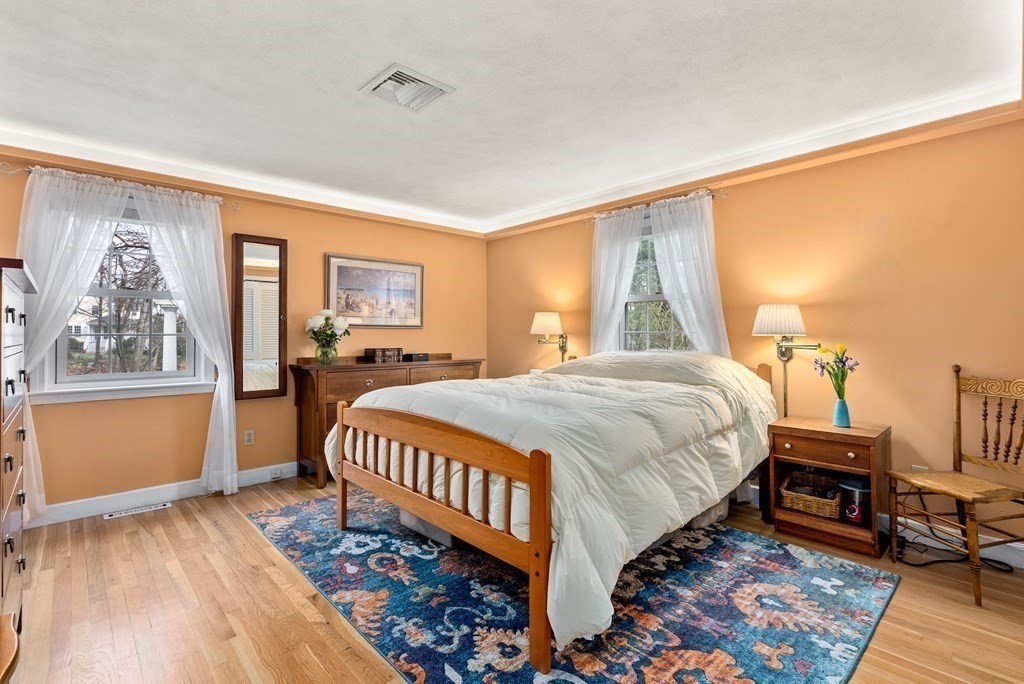42 Bradyll Road Weston, MA 02493 - Photo 17 of 31 a spacious bedroom with a bed table and a window