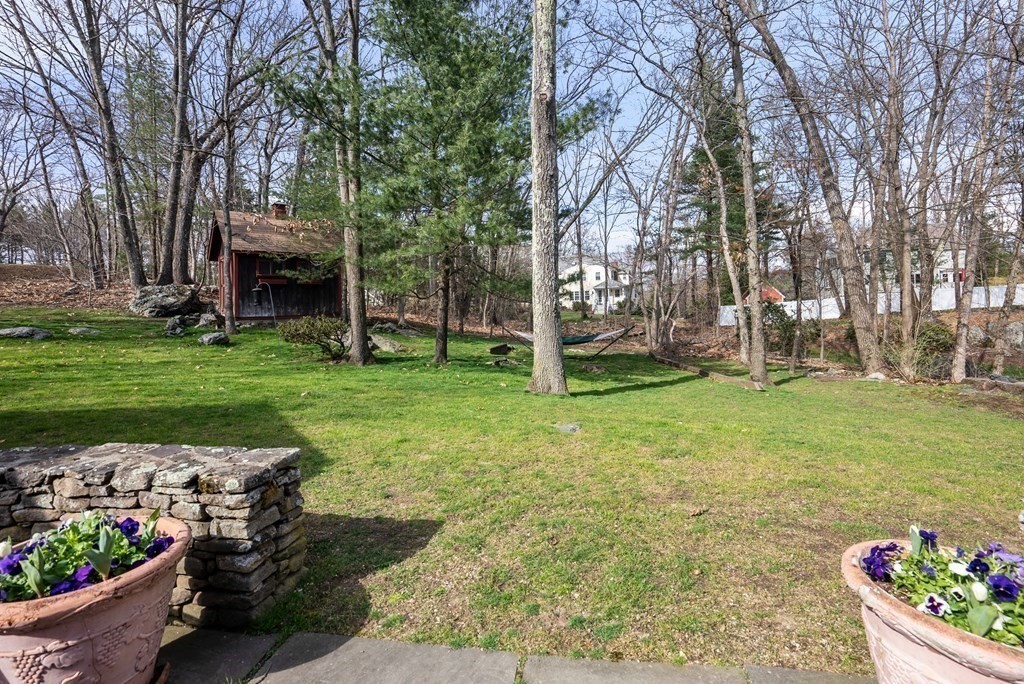 42 Bradyll Road Weston, MA 02493 - Photo 2 of 31 a view of a garden with a fountain