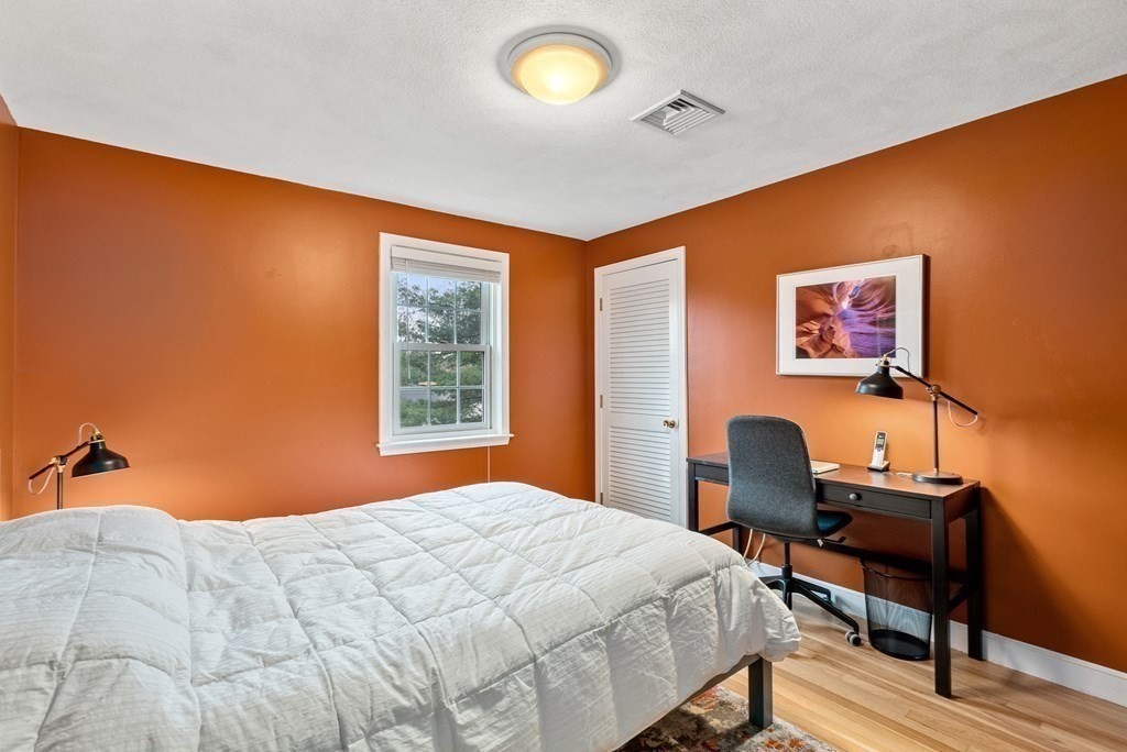 42 Bradyll Road Weston, MA 02493 - Photo 21 of 31 a bedroom with a bed and a desk