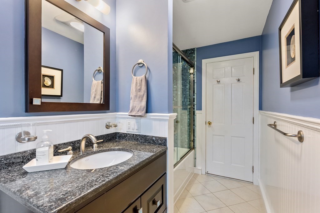 42 Bradyll Road Weston, MA 02493 - Photo 23 of 31 a bathroom with a granite countertop sink and a mirror