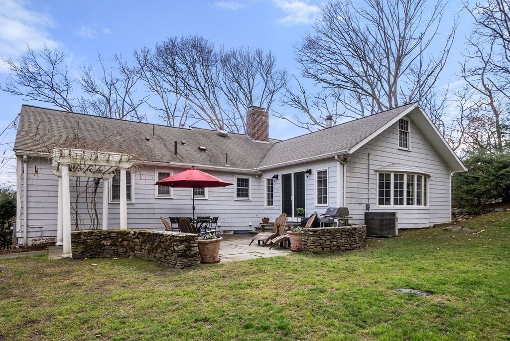 42 Bradyll Road Weston, MA 02493 - Photo 29 of 31 a backyard of a house with yard fire pit and outdoor seating