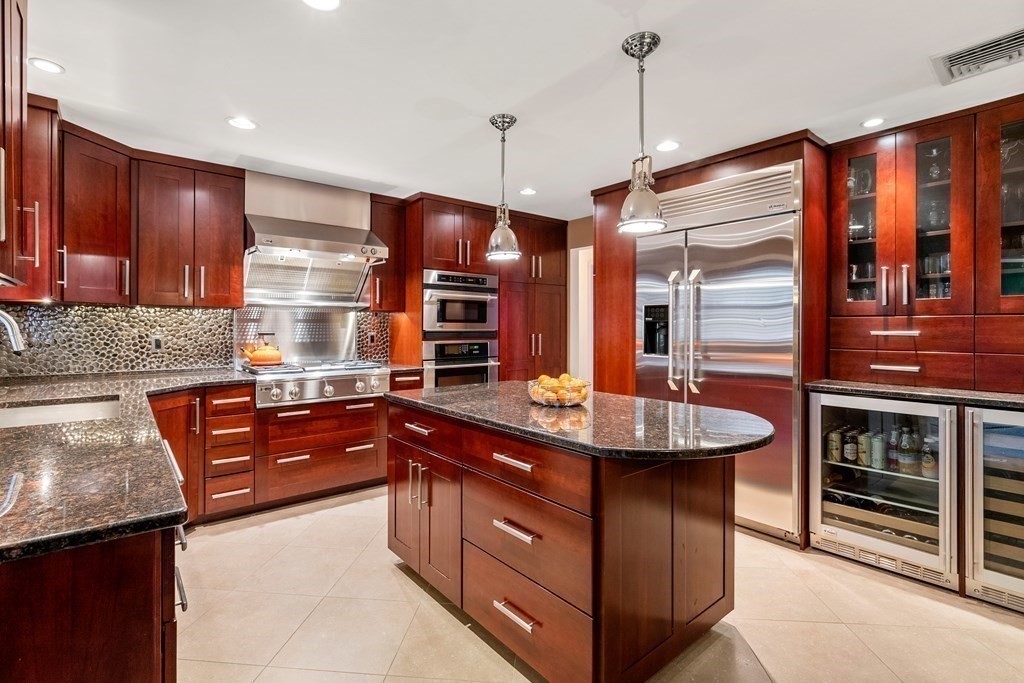42 Bradyll Road Weston, MA 02493 - Photo 5 of 31 a kitchen with stainless steel appliances granite countertop wooden cabinets a oven and a sink
