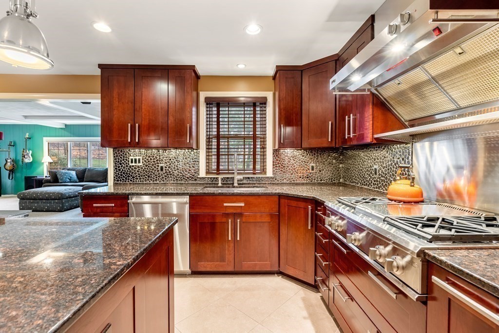 42 Bradyll Road Weston, MA 02493 - Photo 6 of 31 a kitchen with stainless steel appliances granite countertop a sink stove and cabinets