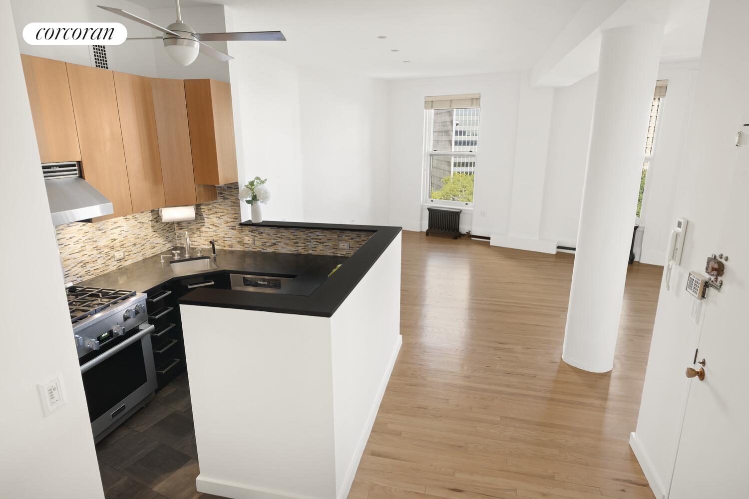 145 Nassau Street, Unit 8A Manhattan, NY 10038 - Photo 22 of 26 a kitchen with a sink stove and cabinets