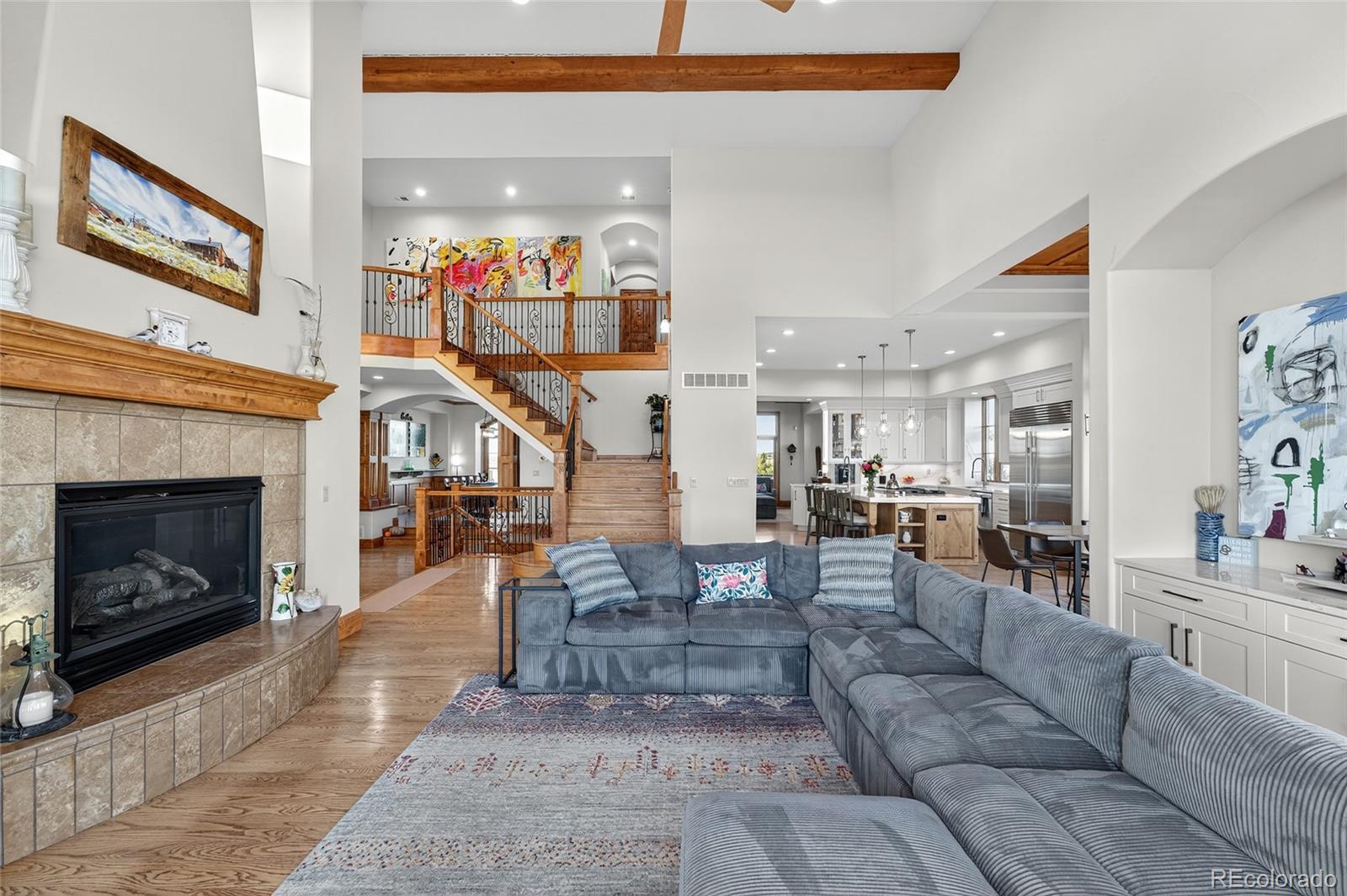 5001 Raintree Circle Parker, CO 80134 - Photo 17 of 50 a living room with furniture a fireplace and a flat screen tv