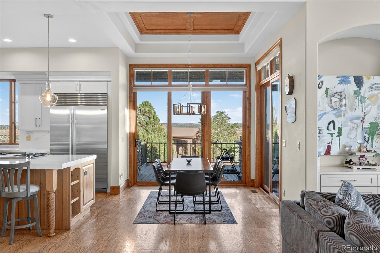5001 Raintree Circle Parker, CO 80134 - Photo 18 of 50 a living room with furniture a wooden floor and a large window