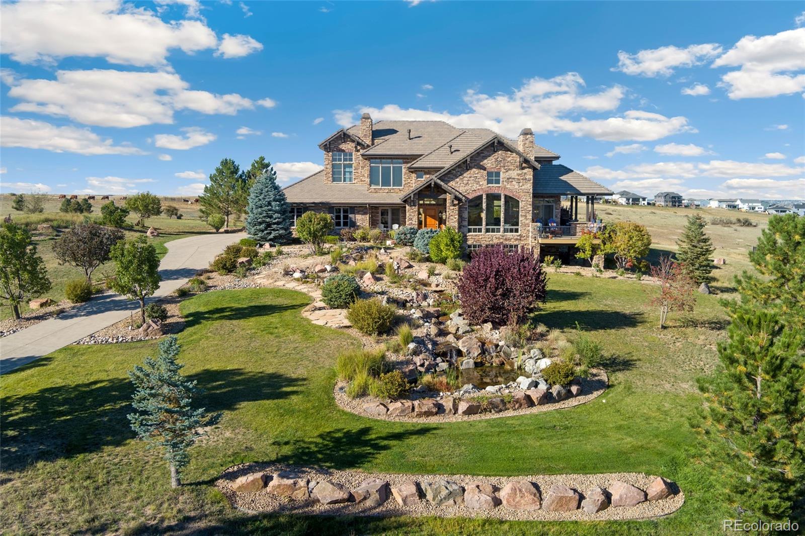 5001 Raintree Circle Parker, CO 80134 - Photo 2 of 50 a aerial view of a house with a garden and lake view