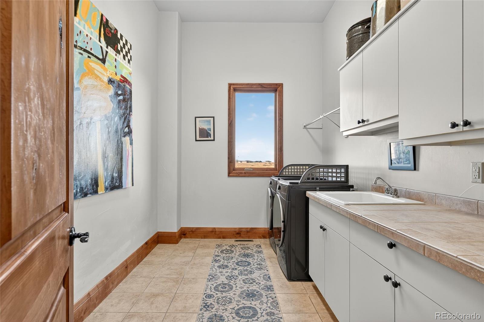 5001 Raintree Circle Parker, CO 80134 - Photo 27 of 50 a bathroom with a sink and a mirror