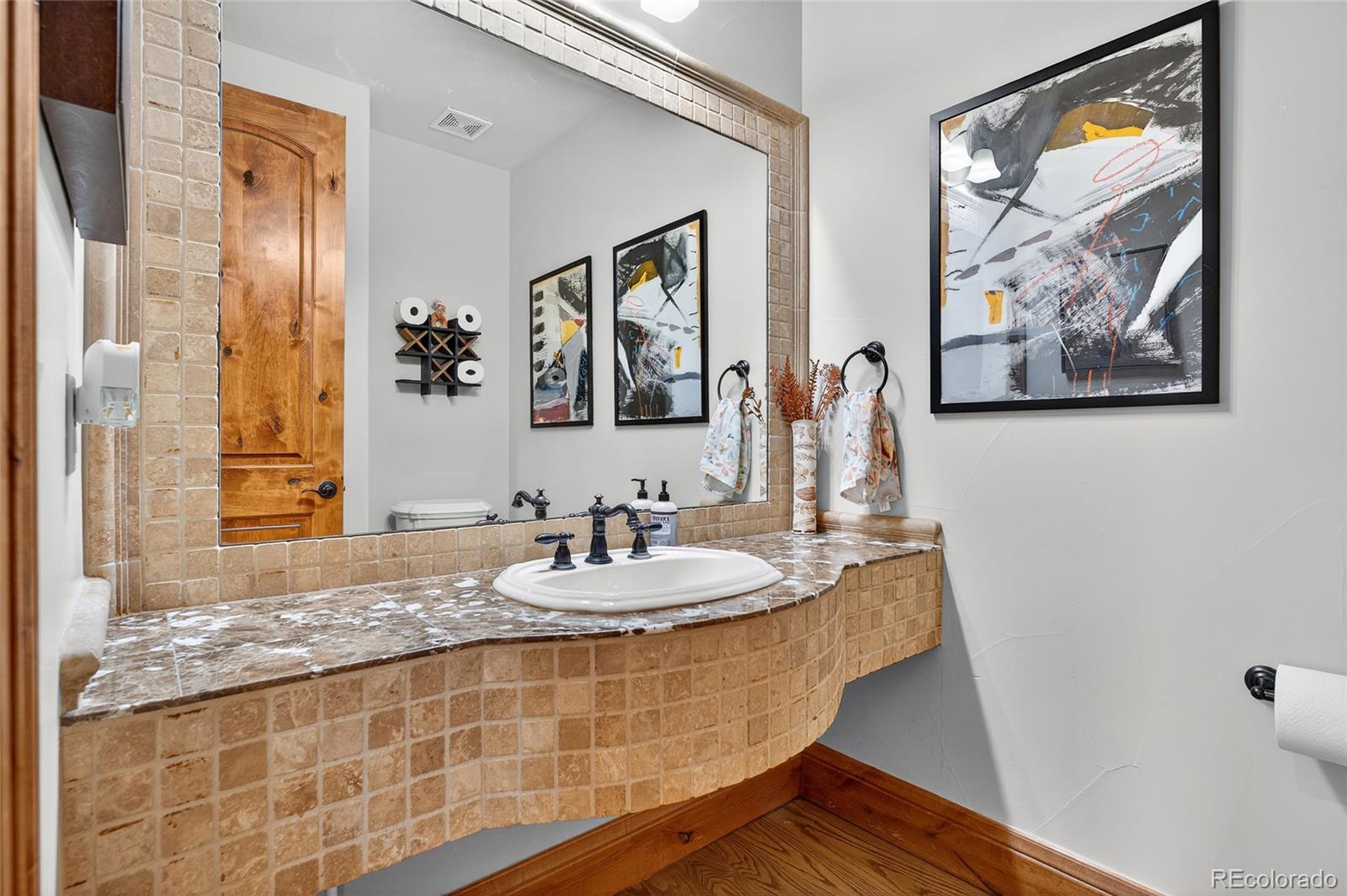5001 Raintree Circle Parker, CO 80134 - Photo 28 of 50 a bathroom with a granite countertop sink a mirror and a shower