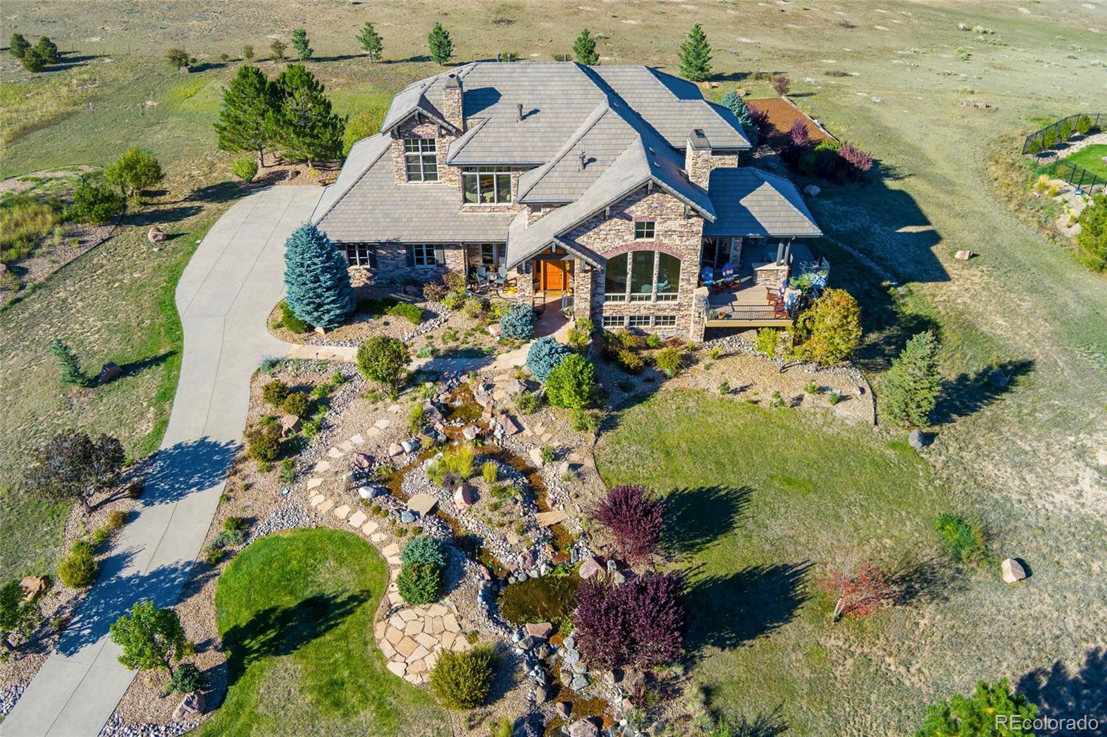 5001 Raintree Circle Parker, CO 80134 - Photo 3 of 50 an aerial view of a house with a yard and lake view