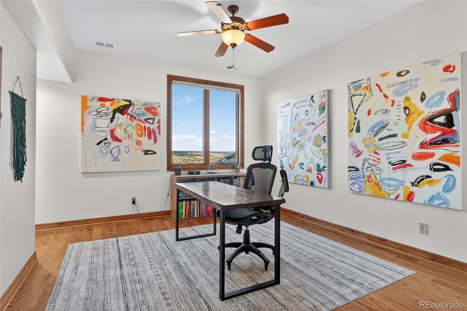 5001 Raintree Circle Parker, CO 80134 - Photo 33 of 50 a workspace with furniture and wooden floor