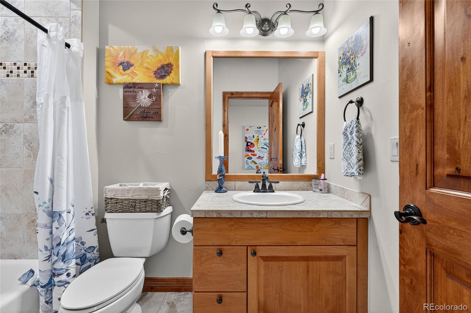 5001 Raintree Circle Parker, CO 80134 - Photo 34 of 50 a bathroom with a granite countertop toilet sink and mirror