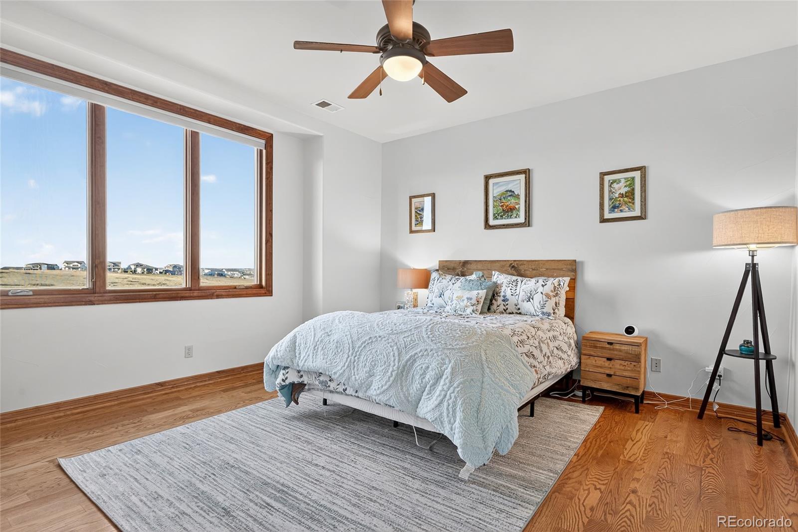 5001 Raintree Circle Parker, CO 80134 - Photo 35 of 50 a bedroom with a bed and window