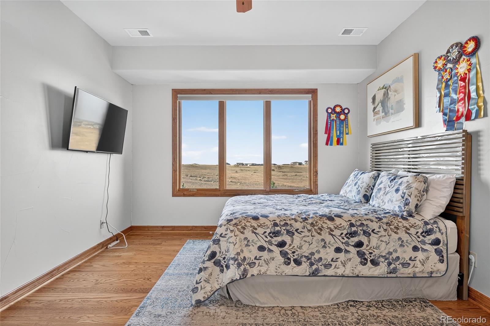 5001 Raintree Circle Parker, CO 80134 - Photo 37 of 50 a bedroom with a large bed and a window