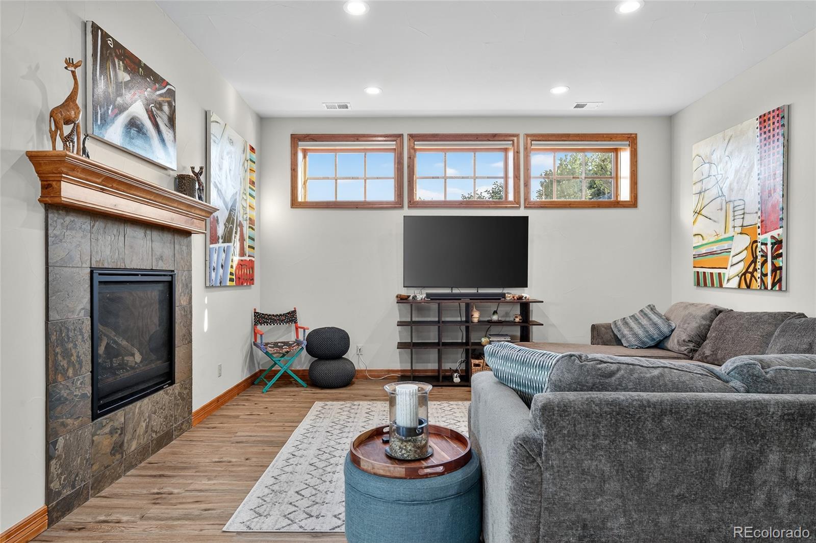 5001 Raintree Circle Parker, CO 80134 - Photo 40 of 50 a living room with furniture a rug and a fireplace