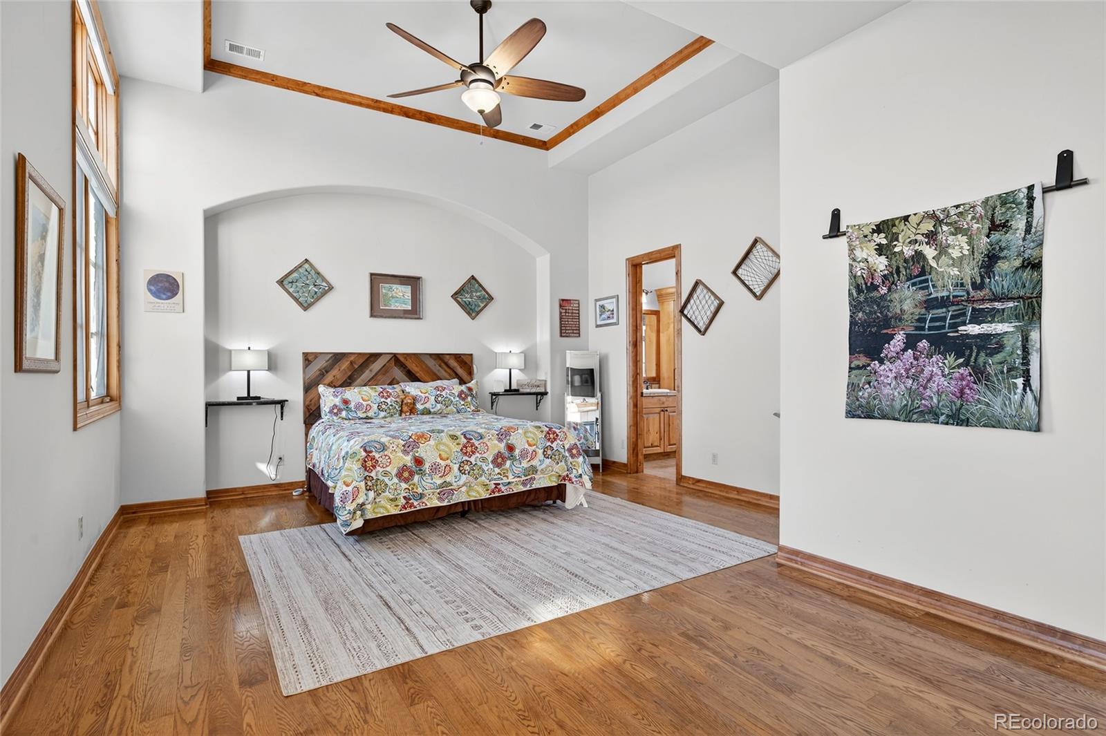 5001 Raintree Circle Parker, CO 80134 - Photo 10 of 50 a bedroom with a bed and a painting on the wall