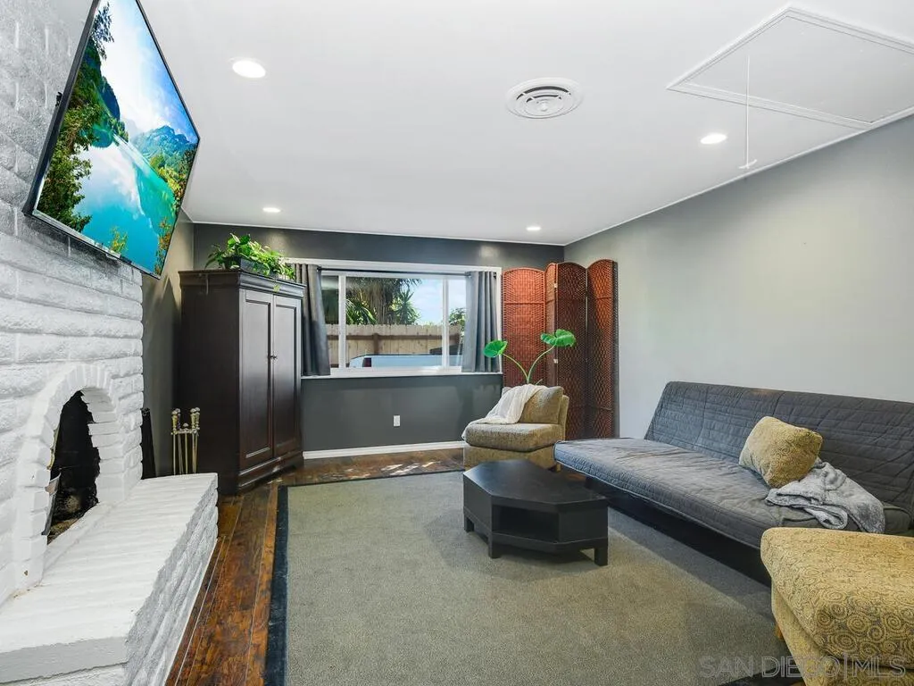 1506 Renwick Lane Vista, CA 92084 - Photo 3 of 28 a living room with furniture flowerpot and a fireplace