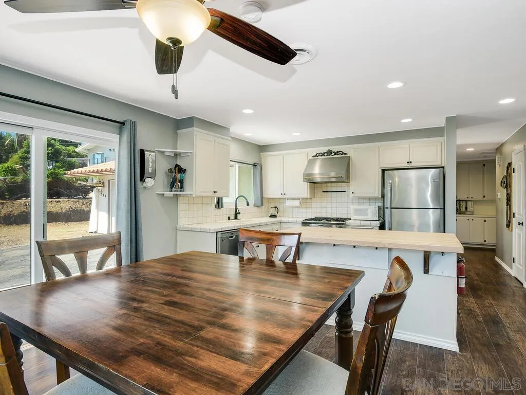 1506 Renwick Lane Vista, CA 92084 - Photo 10 of 28 a large kitchen with kitchen island a table and chairs