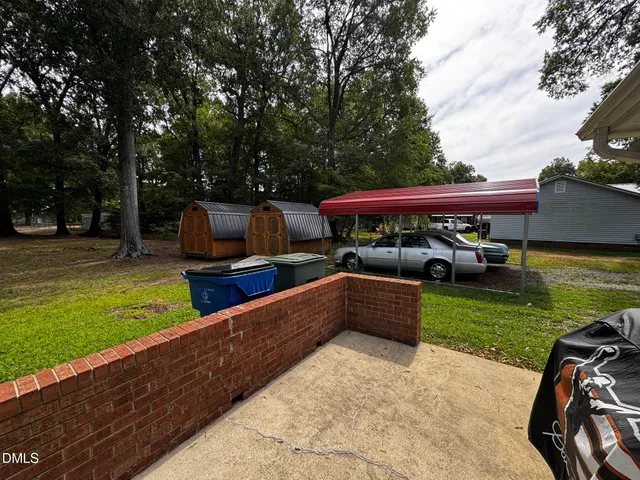 a view of an outdoor sitting area with brick walls