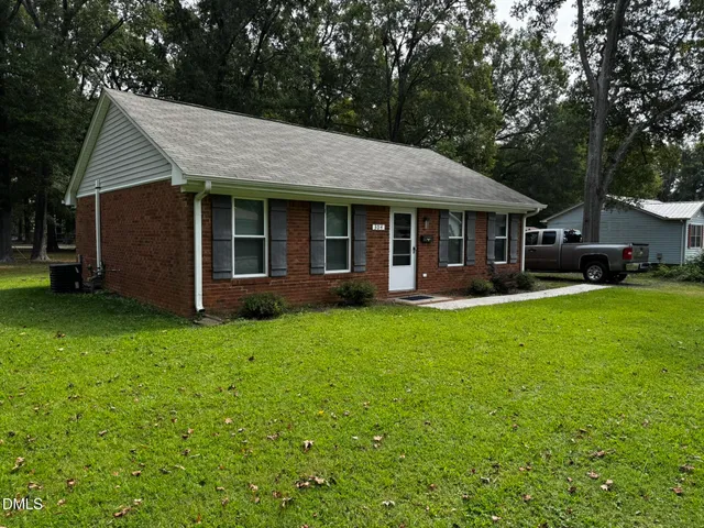 a view of a house with backyard porch and sitting area