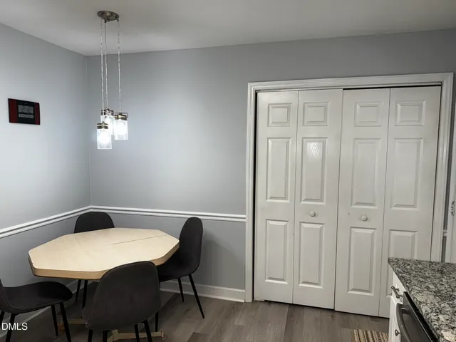 a view of a dining room with furniture and wooden floor