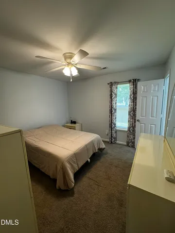 a bed sitting in a room next to a window