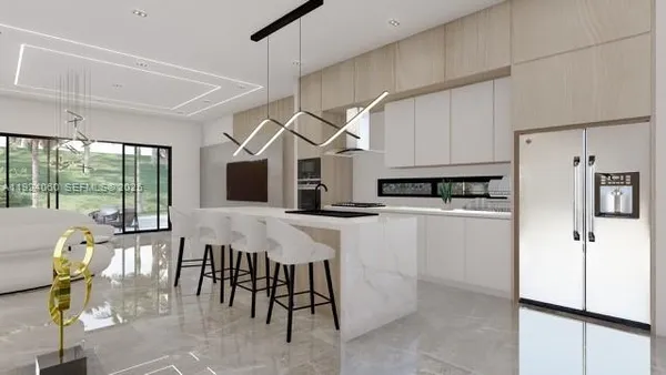 a kitchen with stainless steel appliances kitchen island granite countertop a refrigerator and microwave
