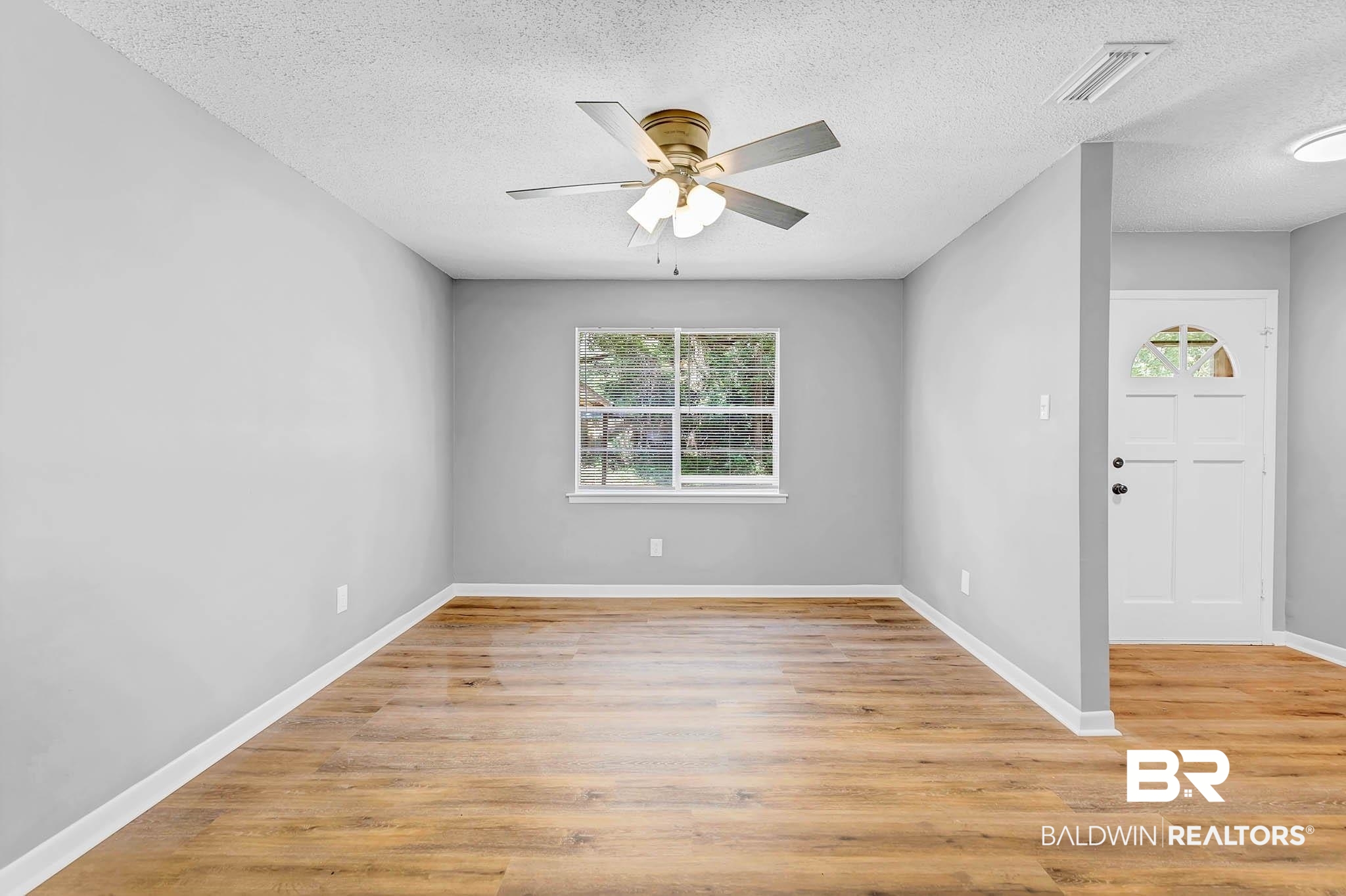 3304 Armond Drive Mobile, AL 36605 - Photo 8 of 62 Unfurnished room featuring a textured ceiling, ceiling fan, and light wood-style floors
