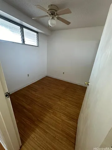 a view of a big room with wooden floor and windows in a room