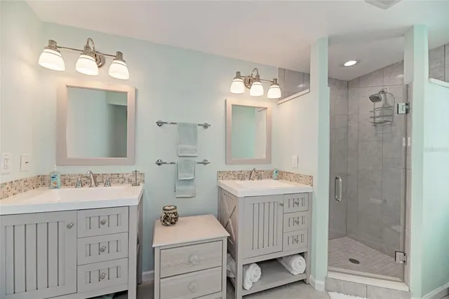 a bathroom with a sink double vanity and a mirror