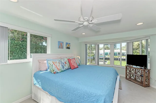 a bedroom with a large bed and a flat screen tv