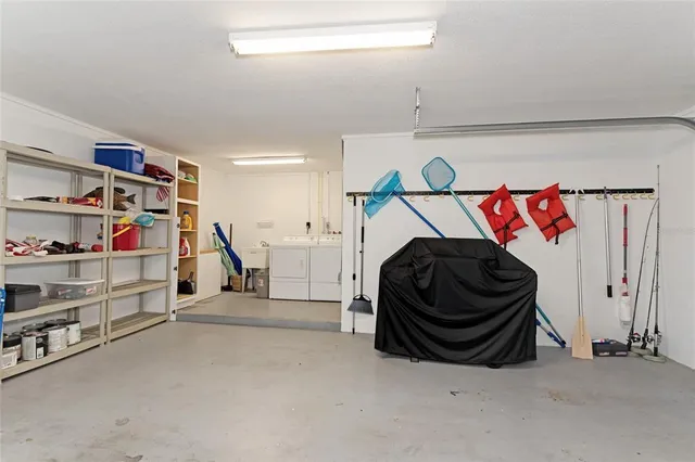 a utility room with a washing machine and storage