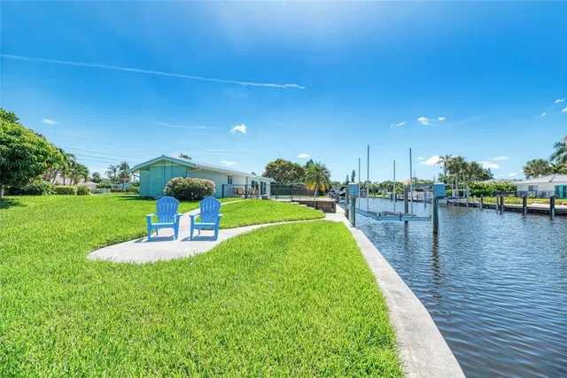 a swimming pool with outdoor seating and yard