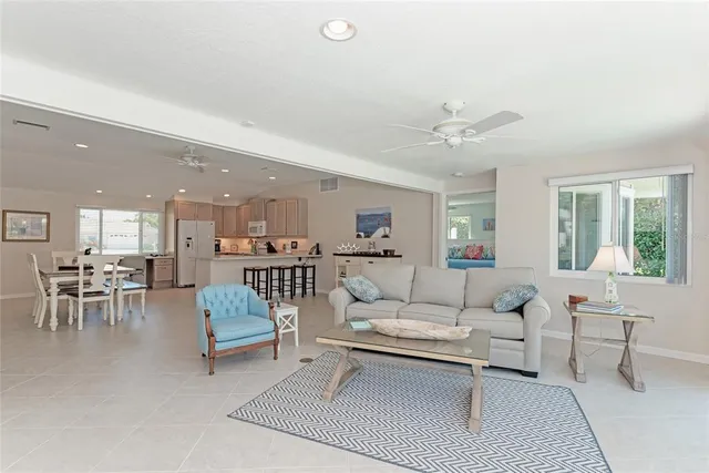 a living room with furniture a table and a large window