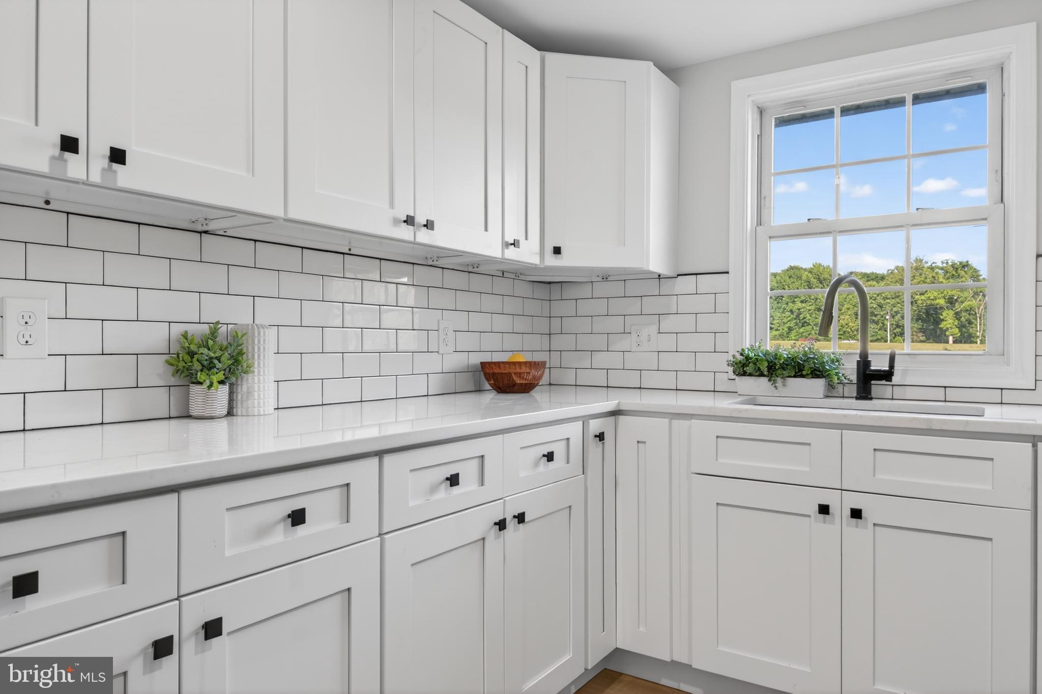 22045 Carters Gate Road Ruther Glen, VA 22546 - Photo 11 of 27 a kitchen with white cabinets and window