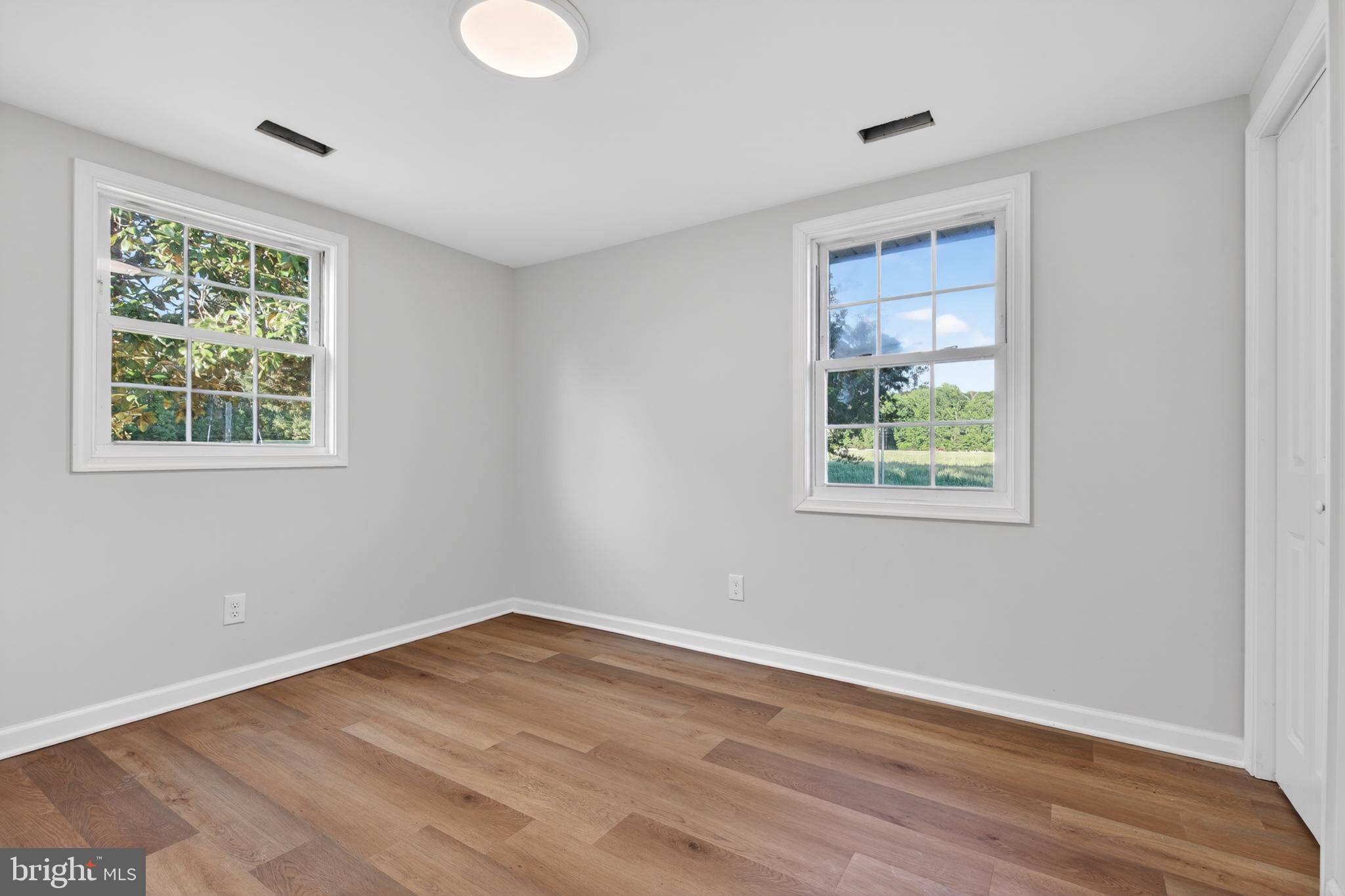 22045 Carters Gate Road Ruther Glen, VA 22546 - Photo 22 of 27 a view of an empty room with wooden floor and a window