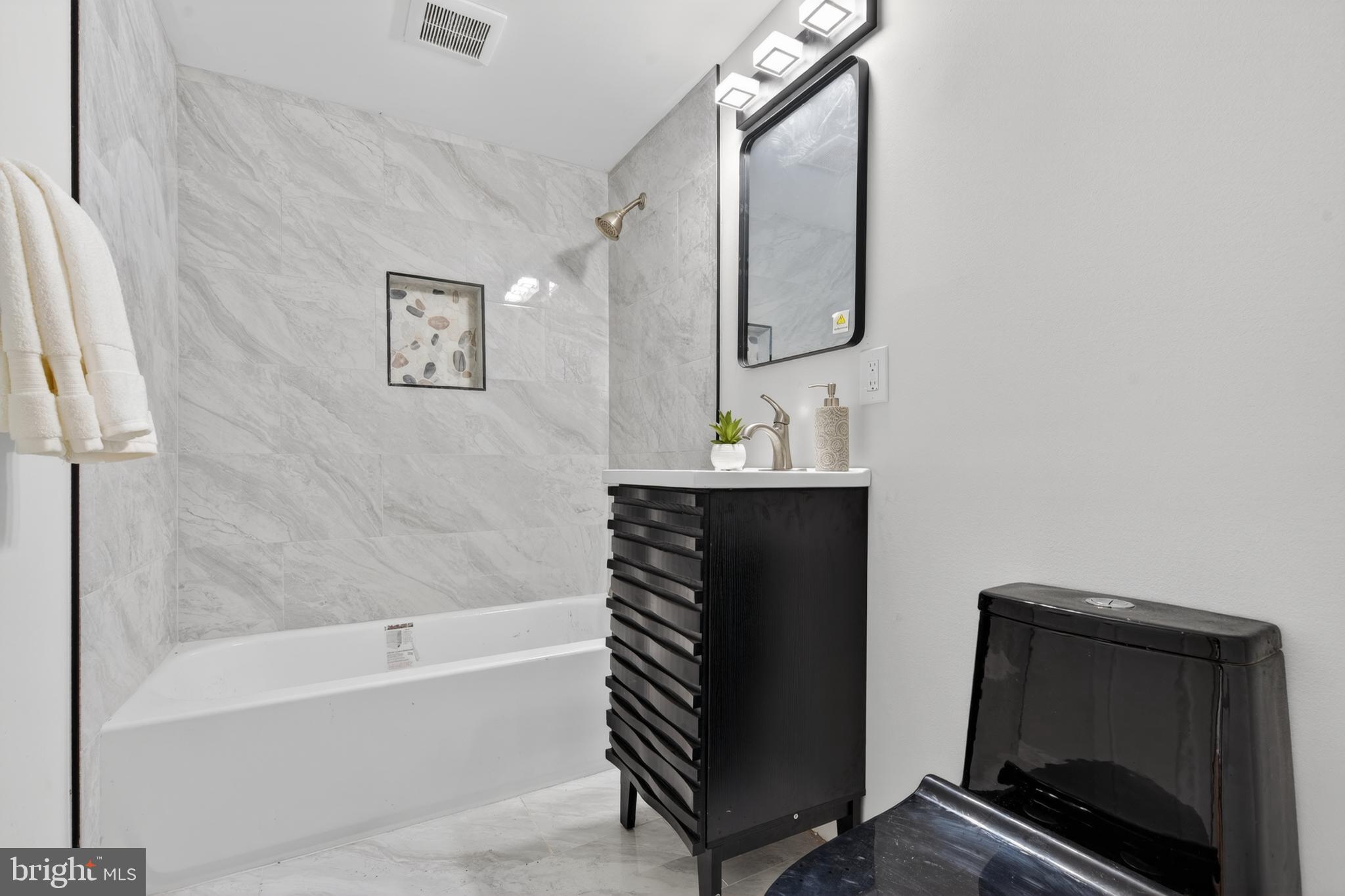 22045 Carters Gate Road Ruther Glen, VA 22546 - Photo 24 of 27 a bathroom with a bathtub and a shower