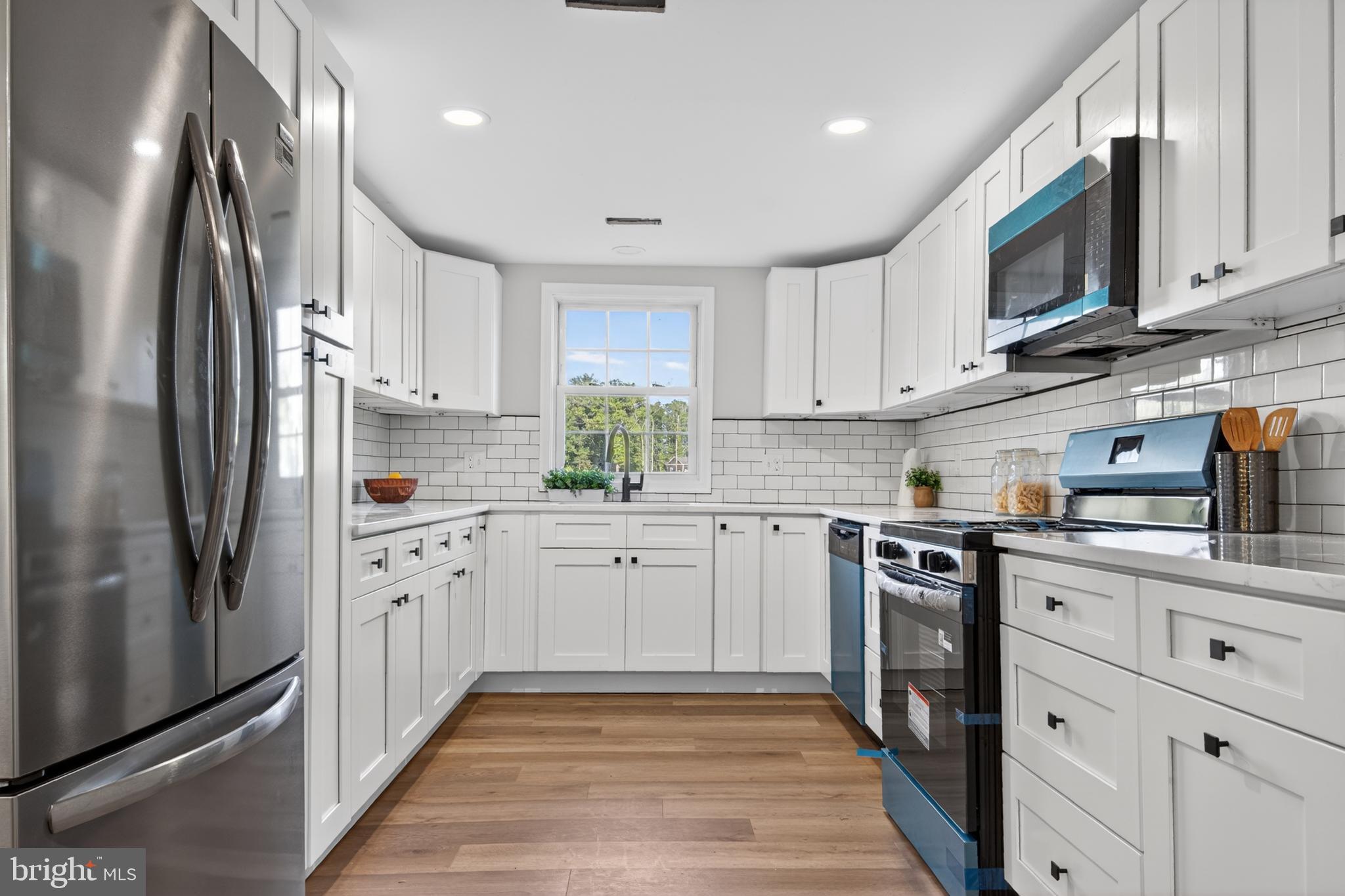 22045 Carters Gate Road Ruther Glen, VA 22546 - Photo 7 of 27 a kitchen with stainless steel appliances granite countertop a refrigerator sink and cabinets