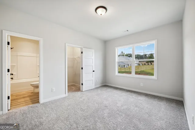 a front view of a house with a garden and plants