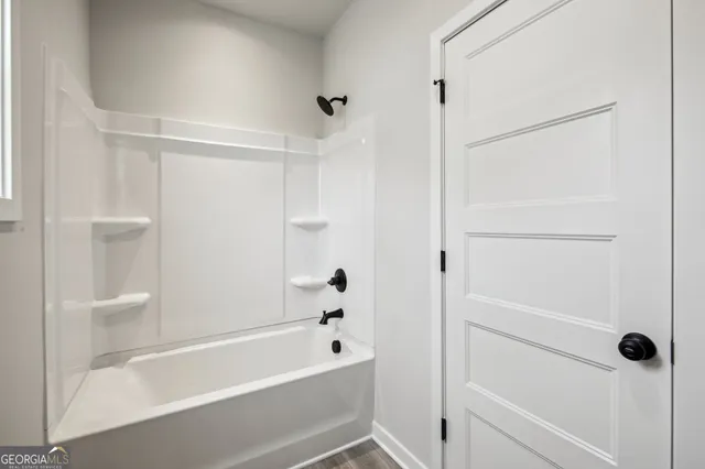 a view of a house with a yard and potted plants