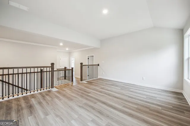 a view of a lake with a palm tree next to a road