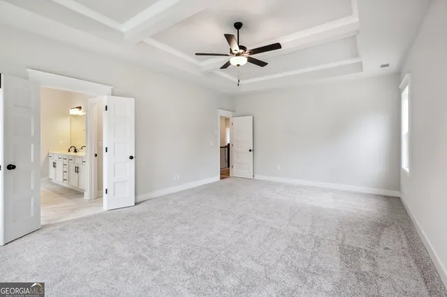 a front view of a building with cars parked