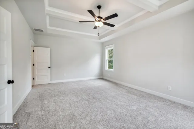 a front view of a house with a garden and plants