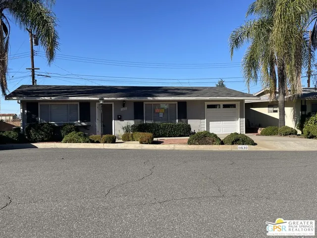 a view of a house with outdoor space and palm trees