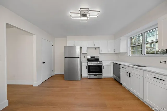 a kitchen with refrigerator a sink and cabinets