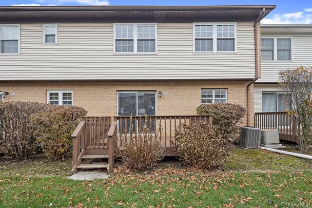 a view of a house with a yard and wooden fence