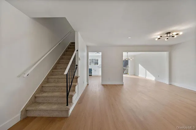 a view of an entryway with wooden floor